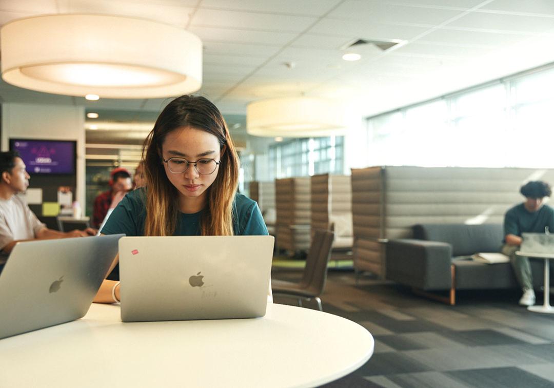 Student looking at laptop on a desk